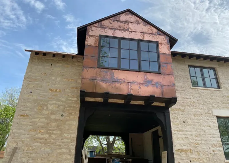 Copper metal panel facade on a stone building for Skylight Installation in East Longmeadow